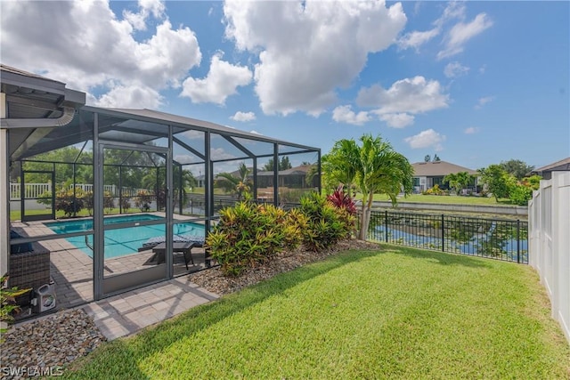 view of swimming pool featuring a lawn, glass enclosure, a patio area, and a water view