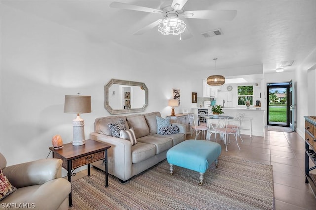 living room with ceiling fan and light tile patterned floors