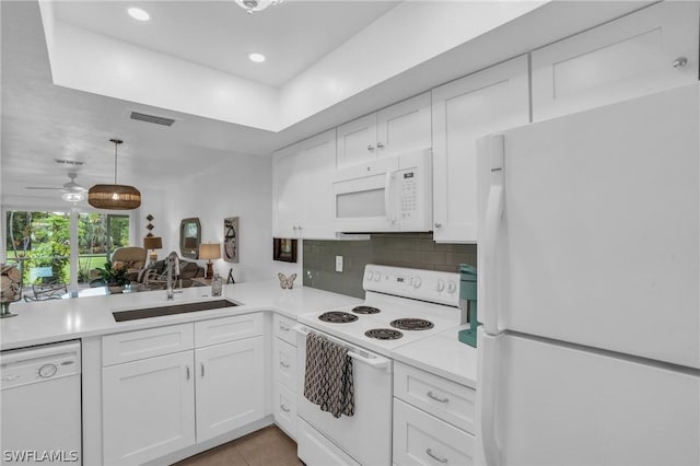 kitchen with tasteful backsplash, white appliances, ceiling fan, sink, and white cabinets