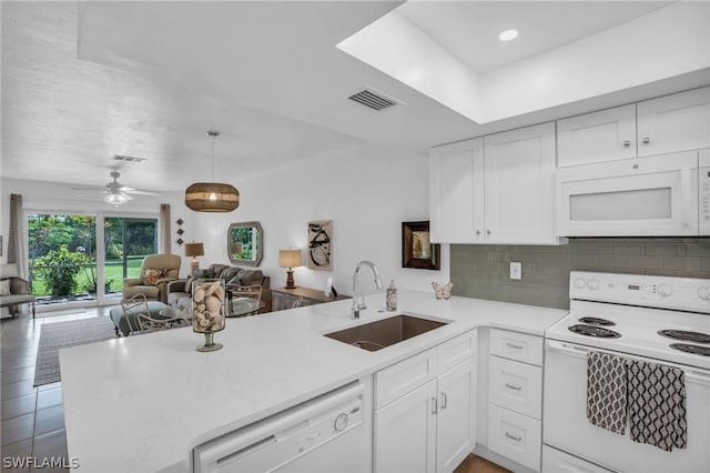 kitchen featuring kitchen peninsula, sink, white cabinets, and white appliances