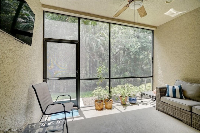 sunroom / solarium featuring ceiling fan