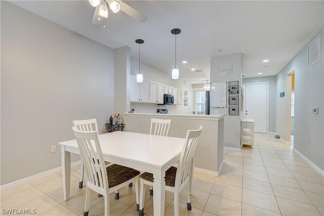 dining space featuring light tile patterned floors and ceiling fan