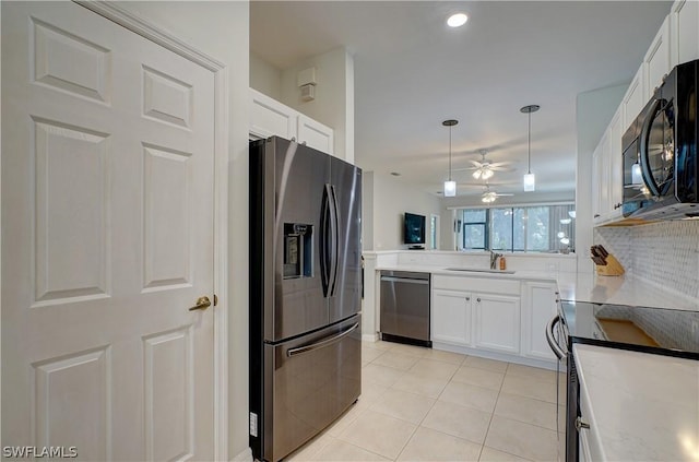 kitchen with light tile patterned floors, stainless steel appliances, sink, and white cabinets