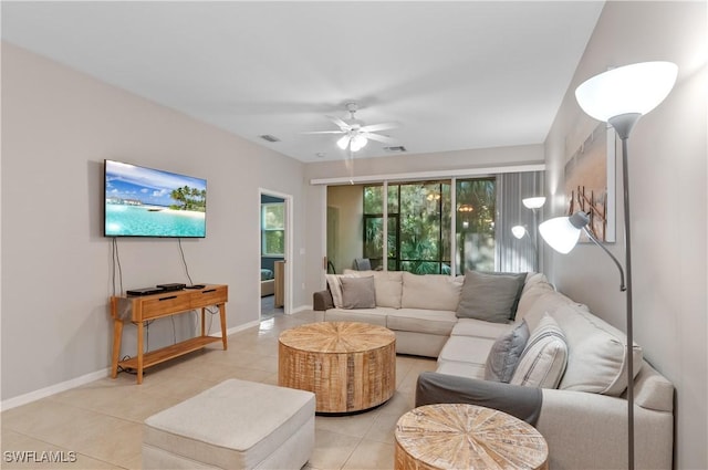 living room featuring ceiling fan and light tile patterned flooring