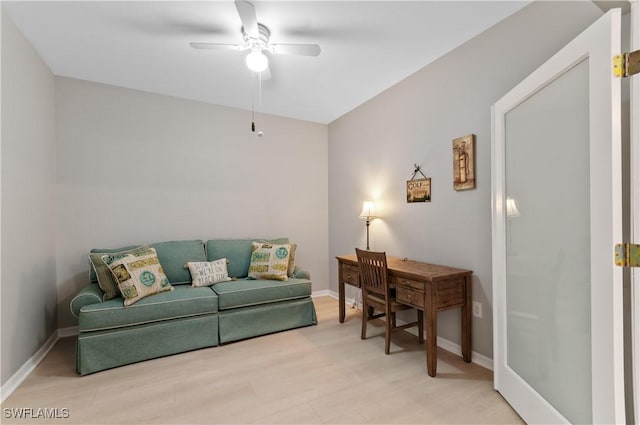 living room featuring ceiling fan and light hardwood / wood-style floors