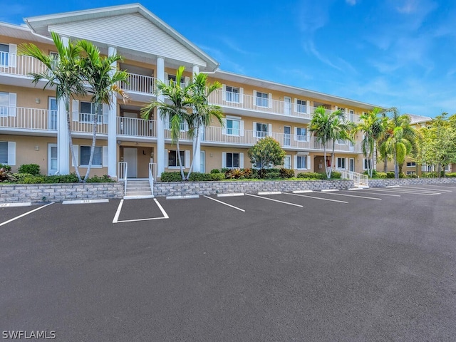 view of property featuring uncovered parking