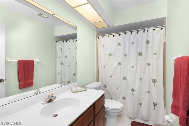 bathroom featuring tile patterned flooring, vanity, curtained shower, and toilet