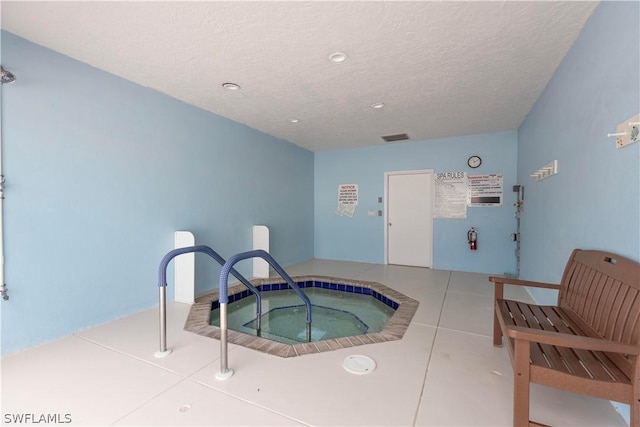 view of swimming pool with an indoor hot tub