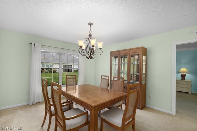 carpeted dining area with a textured ceiling and a chandelier