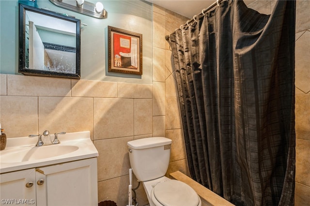 bathroom featuring vanity, toilet, tile walls, and a shower with curtain