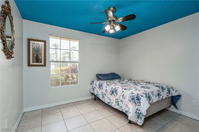 tiled bedroom featuring ceiling fan