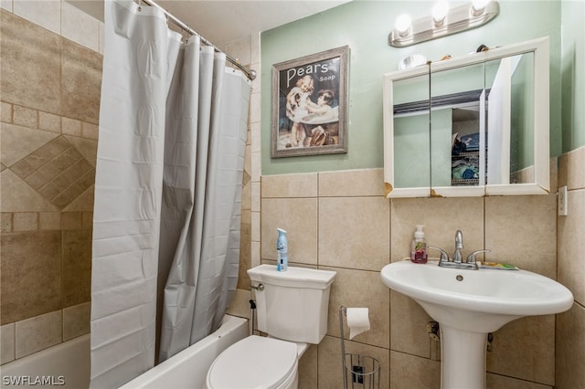 bathroom featuring tile walls, shower / bath combo, and toilet