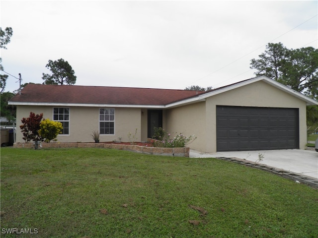 ranch-style house featuring a front yard and a garage