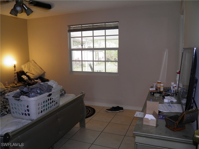 bedroom with ceiling fan and light tile patterned floors