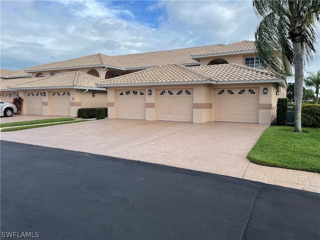 mediterranean / spanish-style house with a garage