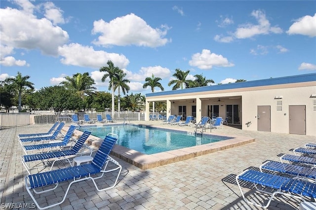 view of pool with ceiling fan and a patio