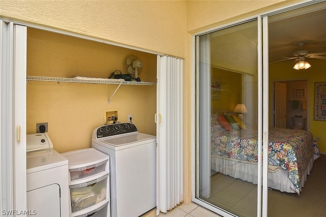 14931 Park Lake Dr Unit 109, Fort Myers, FL 33919 - laundry area with washer and dryer, ceiling fan, and light tile patterned floors