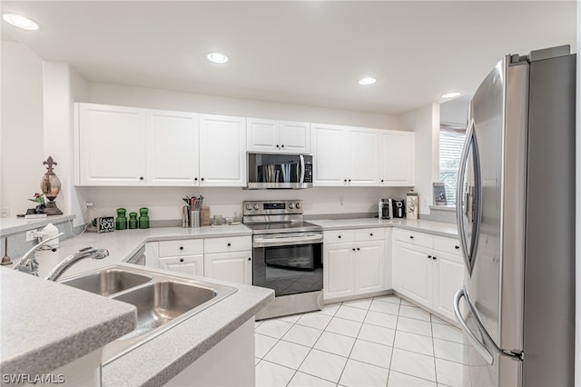 kitchen featuring white cabinets, light tile patterned flooring, sink, and appliances with stainless steel finishes