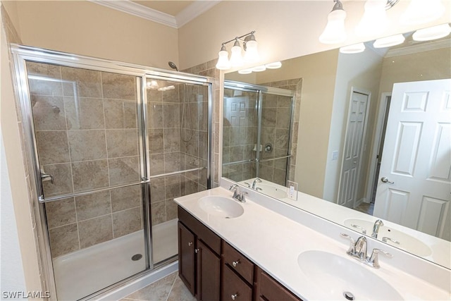 bathroom featuring tile patterned flooring, vanity, ornamental molding, and walk in shower