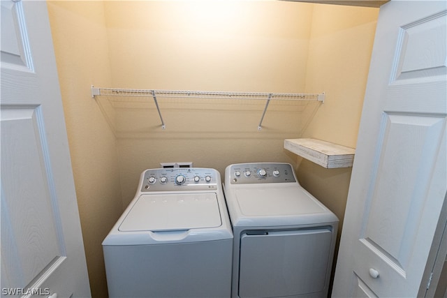 clothes washing area featuring washing machine and clothes dryer