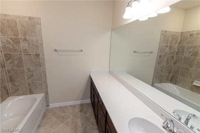 bathroom with tile patterned flooring, vanity, and a washtub