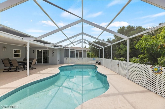 view of swimming pool with a lanai and a patio area