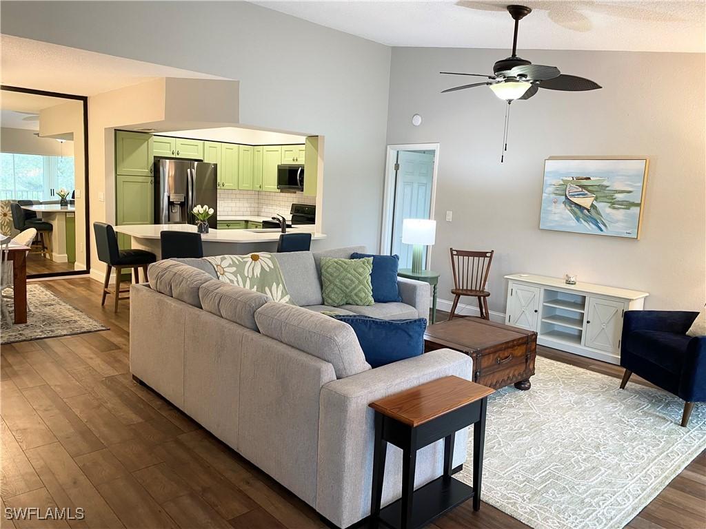 living room featuring hardwood / wood-style floors and ceiling fan