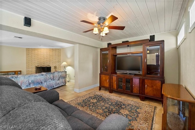 tiled living room with a brick fireplace, ceiling fan, crown molding, and wood ceiling