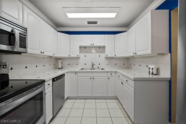 kitchen featuring sink, white cabinets, backsplash, and appliances with stainless steel finishes