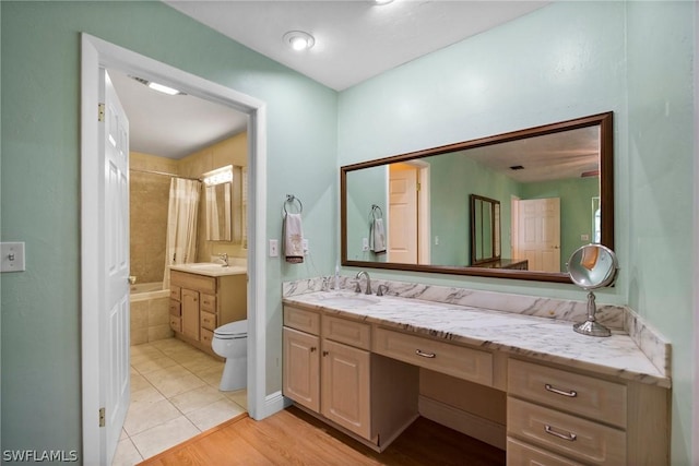 full bathroom featuring vanity, shower / bath combo with shower curtain, tile patterned floors, and toilet