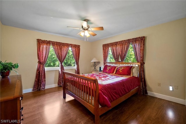 bedroom with ceiling fan and dark wood-type flooring