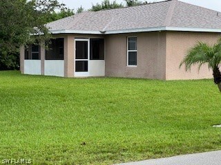 back of house with a yard