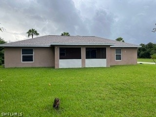 rear view of house with a lawn