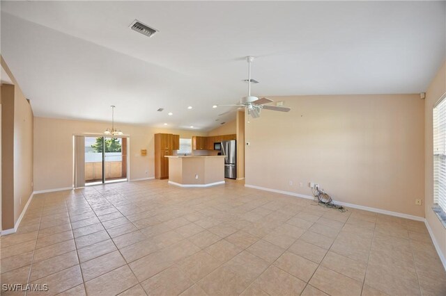 unfurnished living room with light tile patterned floors, ceiling fan with notable chandelier, and vaulted ceiling