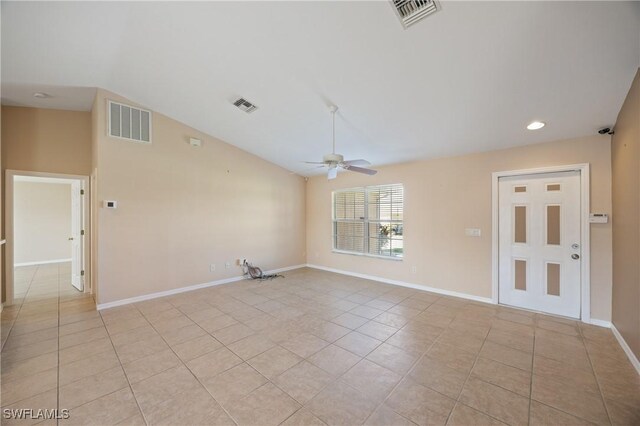 unfurnished room with vaulted ceiling, ceiling fan, and light tile patterned floors