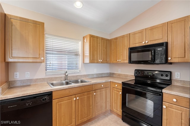 kitchen featuring sink, vaulted ceiling, black appliances, light brown cabinets, and light tile patterned floors