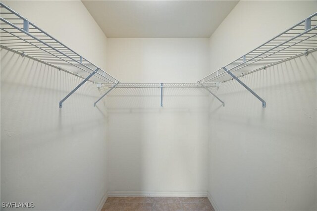 spacious closet featuring tile patterned floors