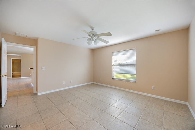 spare room featuring light tile patterned floors and ceiling fan