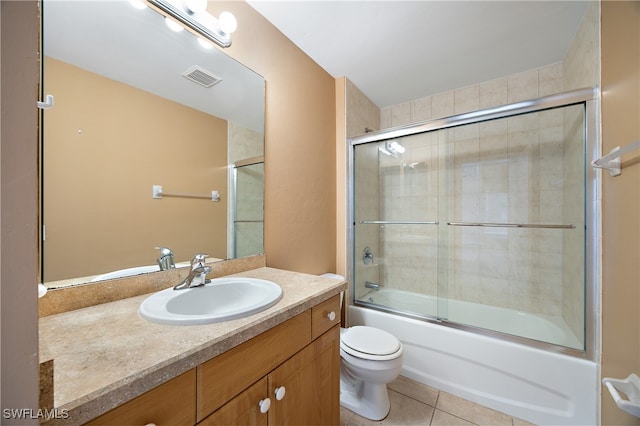 full bathroom with tile patterned floors, shower / bath combination with glass door, vanity, and toilet