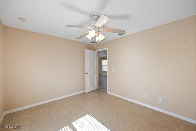 empty room featuring ceiling fan and light tile patterned flooring