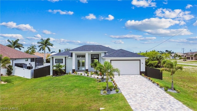 view of front of home featuring a garage and a front lawn