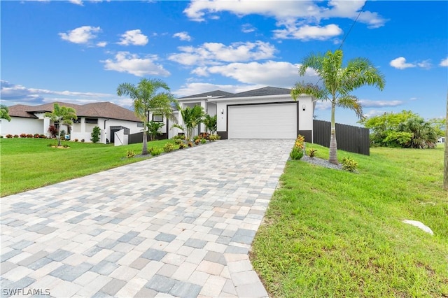 view of front of house featuring a front yard and a garage