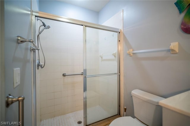 bathroom with an enclosed shower and toilet