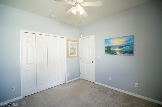 unfurnished bedroom with light carpet, ceiling fan, and a closet