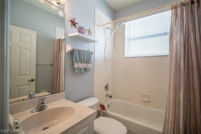 full bathroom with vanity, shower / bath combo with shower curtain, and toilet