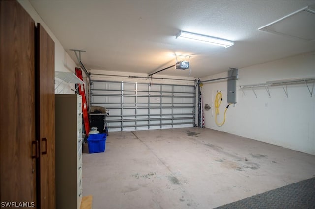 garage with a garage door opener and electric panel