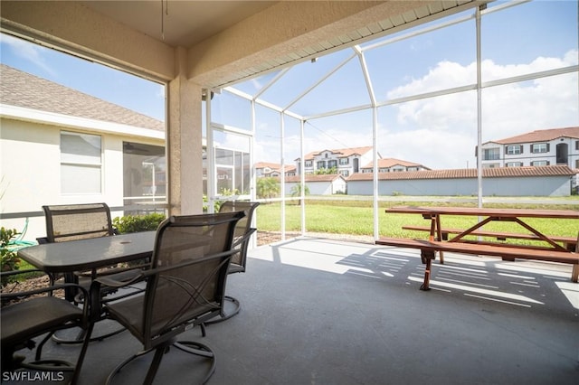 sunroom featuring a water view