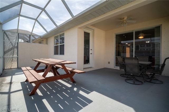 view of patio featuring glass enclosure and ceiling fan