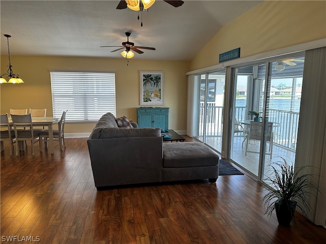 living room with dark wood-type flooring, ceiling fan, and lofted ceiling