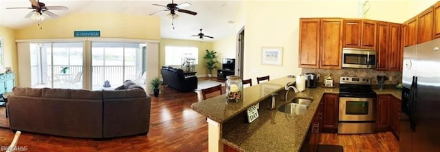 kitchen with sink, ceiling fan, stainless steel appliances, and backsplash